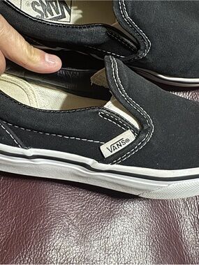 Vans Kids Black Canvas Slip-On Sneakers with White Sole and Red Heel Tag